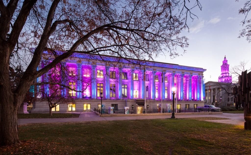 McNichols building at dusk lit up with purple lights