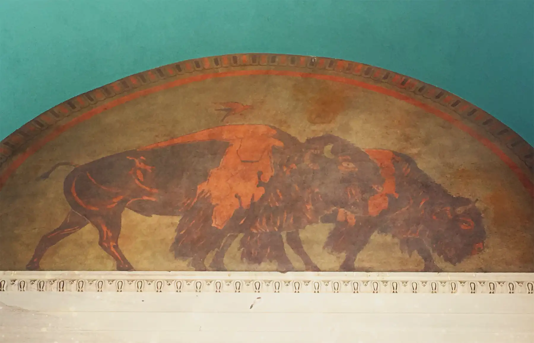 Buffalo mural shows two buffalo in browns and oranges.